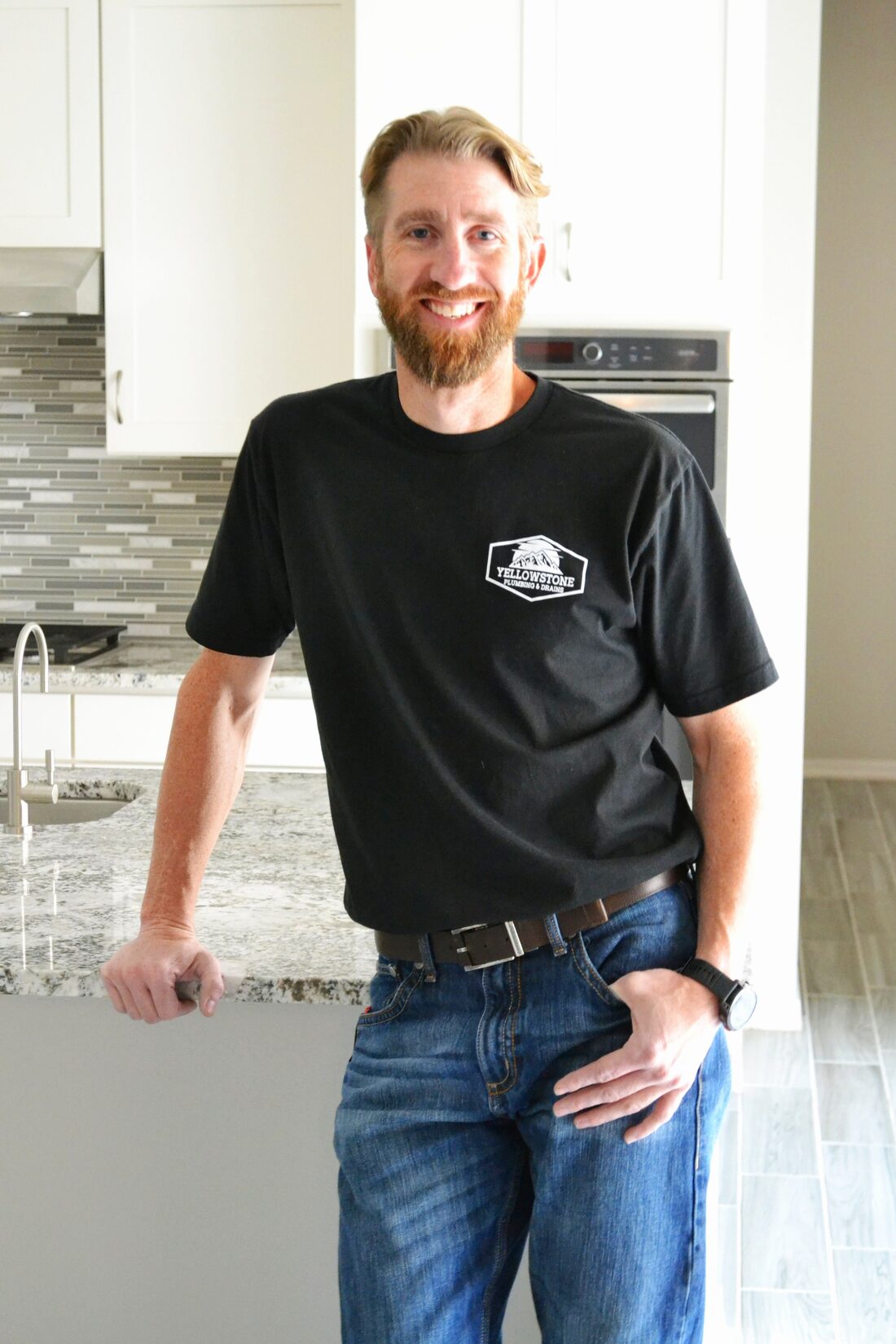 Josh, founder of Yellowstone Plumbing, in a customer's home